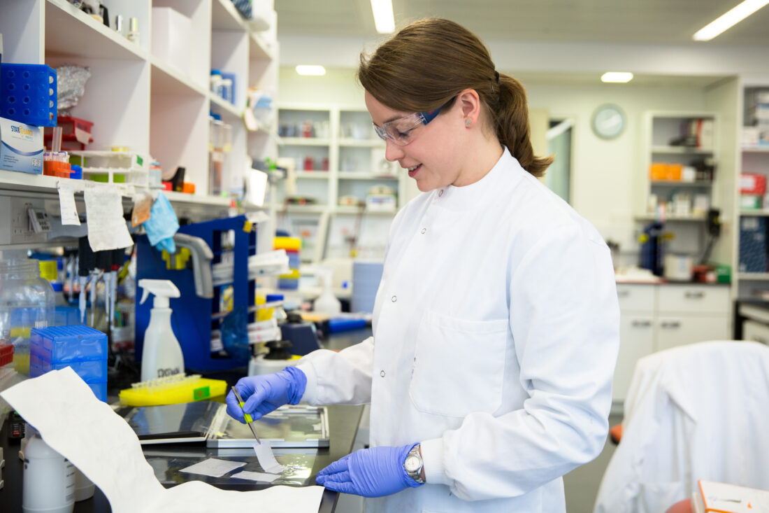 Female scientist preparing gels on a lab bench