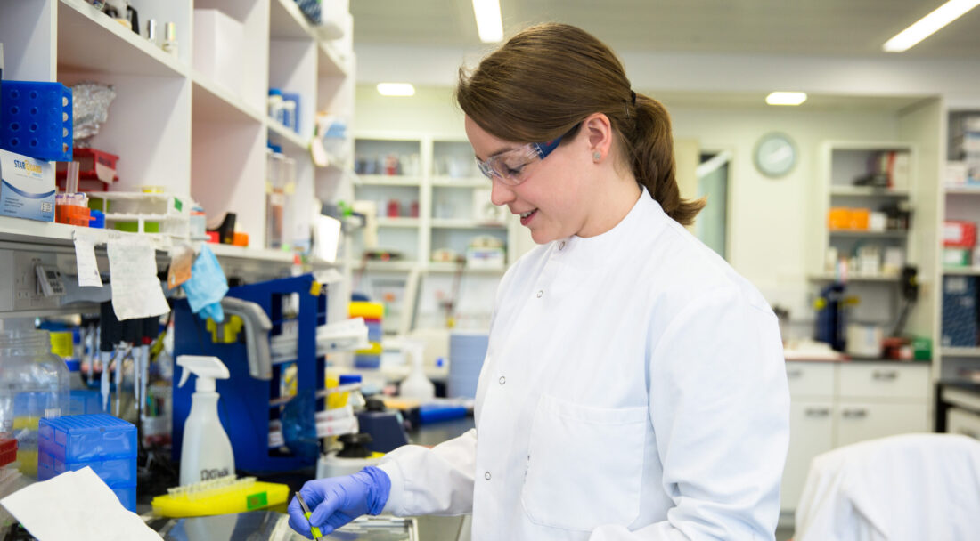 Female scientist preparing gels on a lab bench