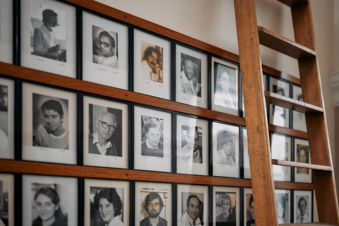 image of black and white portraits on the walls of the Dunn School