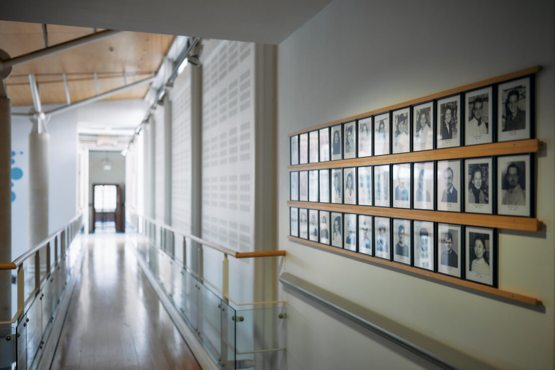 image of black and white portraits on the walls of the Dunn School